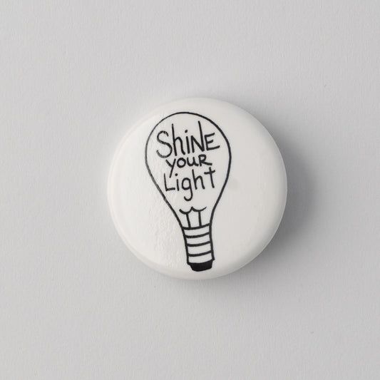 SHINE YOUR LIGHT™ PINBACK BUTTON